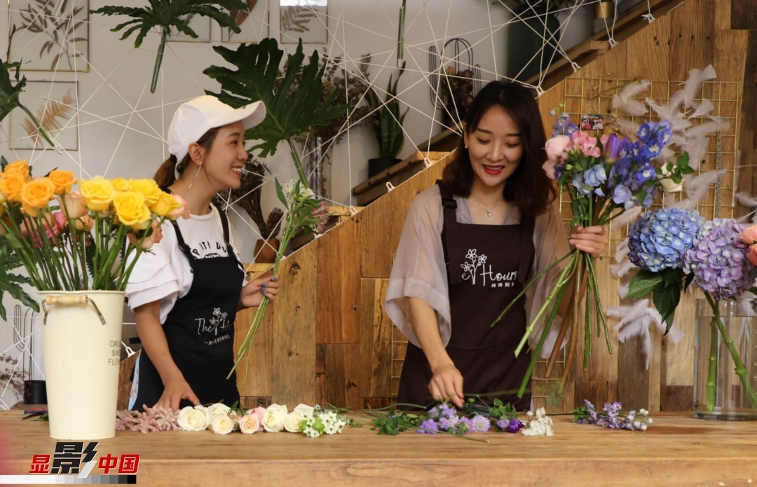 “昆明是鮮花的原產(chǎn)地，有亞洲最大的鮮切花交易市場，可以說具備開花店的天時地利；另外和很多女孩一樣，我從小也就有開花店的夢想！”說起當(dāng)初的決定，王黎媛說一是因為夢想，另外也跟昆明這個城市產(chǎn)花、賣花的“基因”有關(guān)。圖為王黎媛和同事在制作花束。新華網(wǎng) 周亞平/攝 念新洪/文